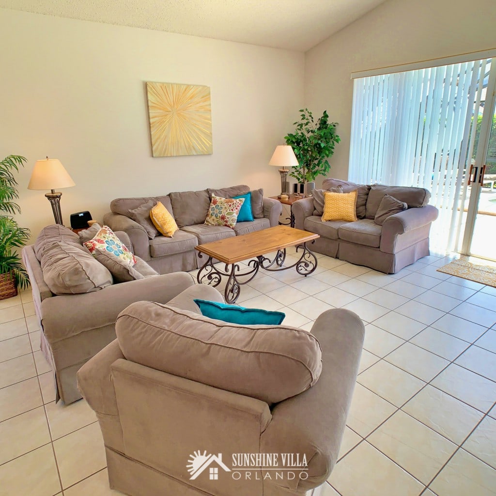 Living Room with a couch, two love seats and a side chair at Sunshine Villa at Glenbrook Resort, a short-term vacation rental home in Orlando near Walt Disney World