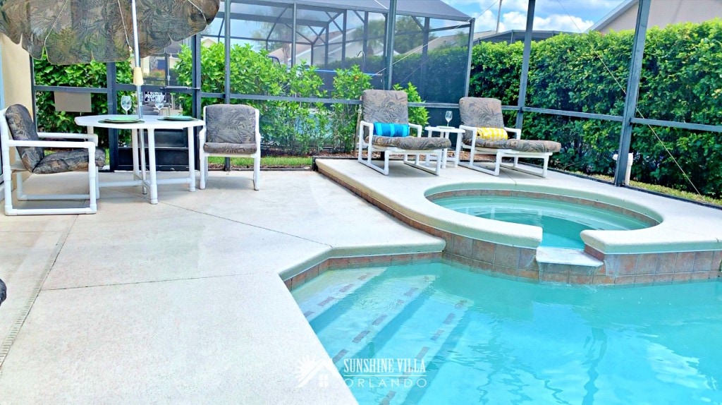 Spa and Pool, Outdoor Umbrella Table and Lounge Chairs on a sunny day in Orlando