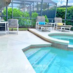 Spa and Pool, Outdoor Umbrella Table and Lounge Chairs on a sunny day in Orlando