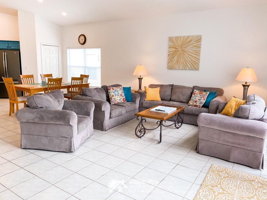 Living Room with a couch, two love seats and a side chair at Sunshine Villa at Glenbrook Resort, a short-term vacation rental home in Orlando near Walt Disney World